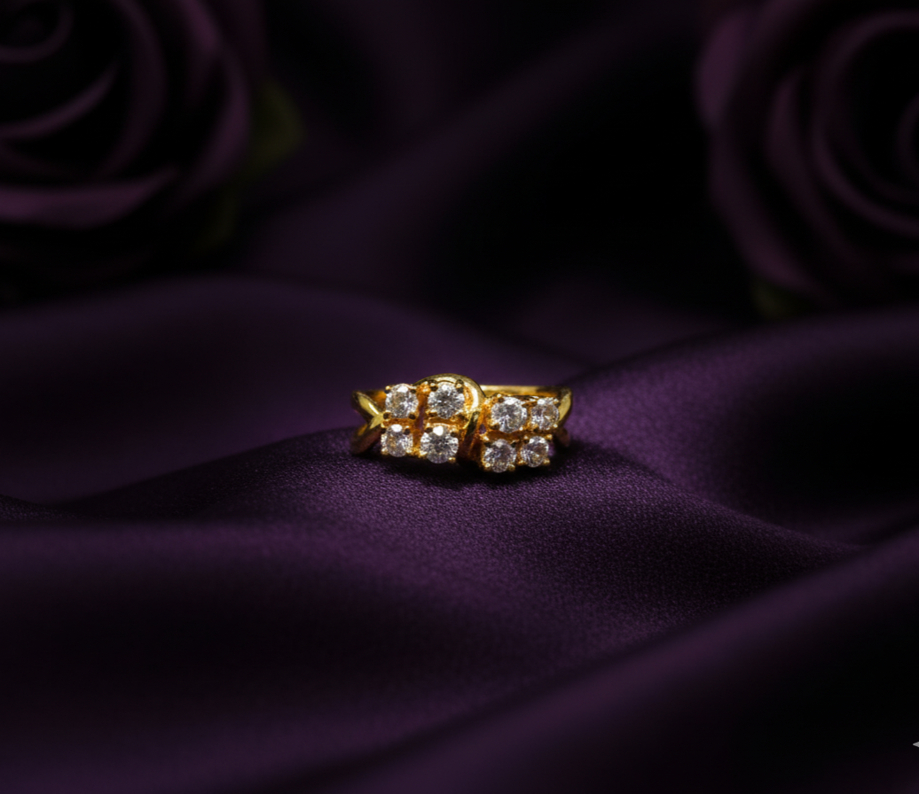 Gold ring with diamonds on a purple fabric background