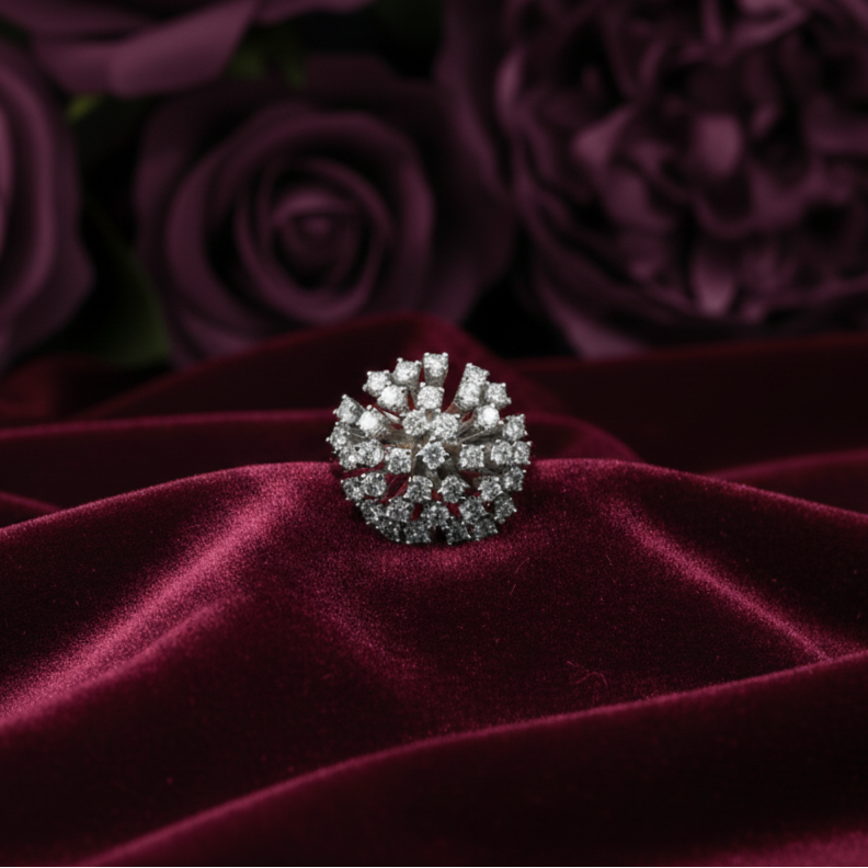 Diamond ring on a burgundy velvet surface with purple roses in the background